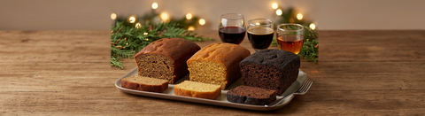 Cahlua Cafe, Amaretto, and Chocolate Merlot dessert cakes with slices and small glasses of red wine, coffee liqueur, and amaretto.