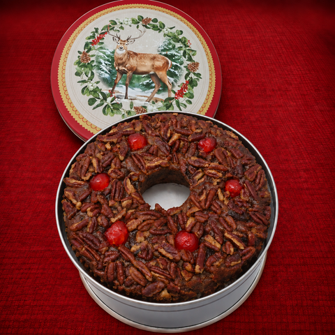 Dark fruitcake with slightly larger red deer lid