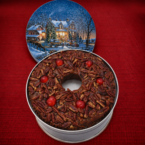Dark fruitcake with slightly larger winter-scene lid
